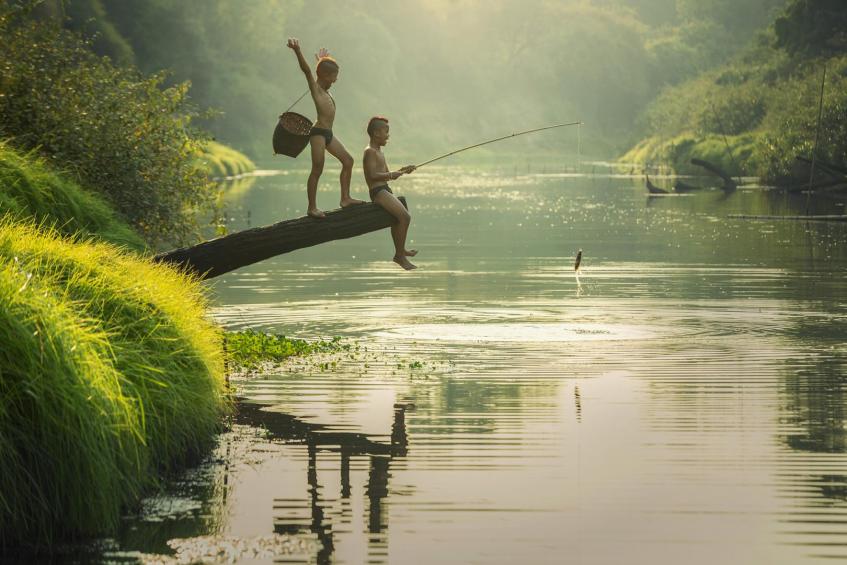 Boy fishing at the river 