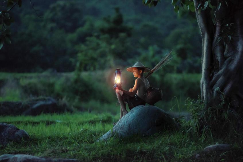 Boy fishing with lantern, Thailand 